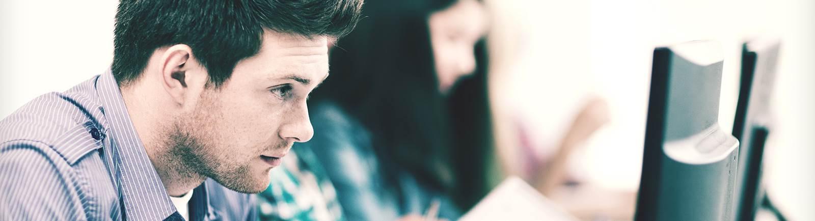 male student looking at computer