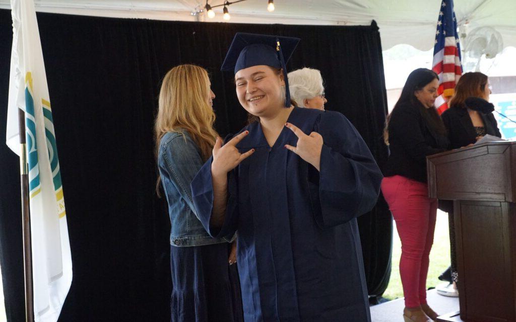 Smiling graduate in cap and gown